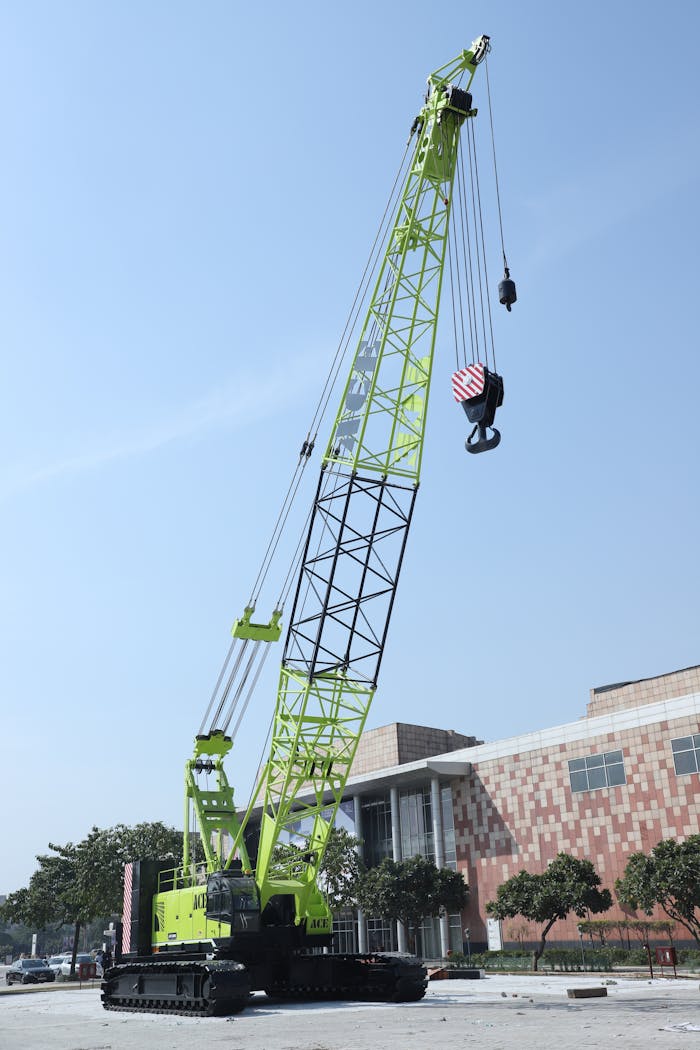 Large crawler crane at a construction site in Faridabad, India, ready for heavy lifting.