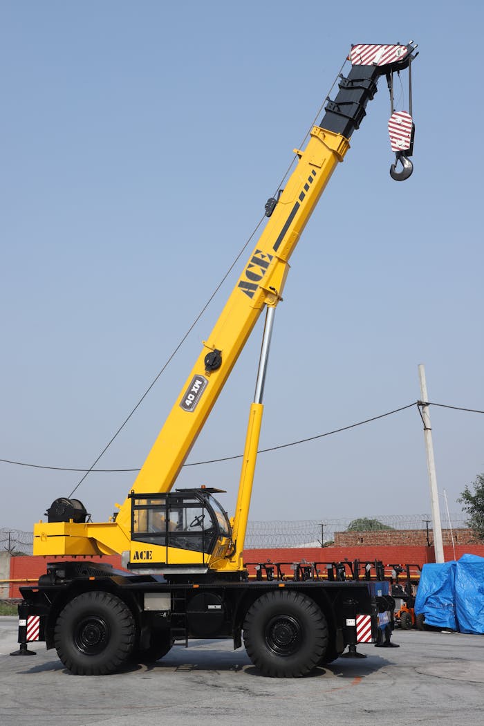 A yellow ACE 40XW rough terrain crane in an outdoor setting in Faridabad, India.