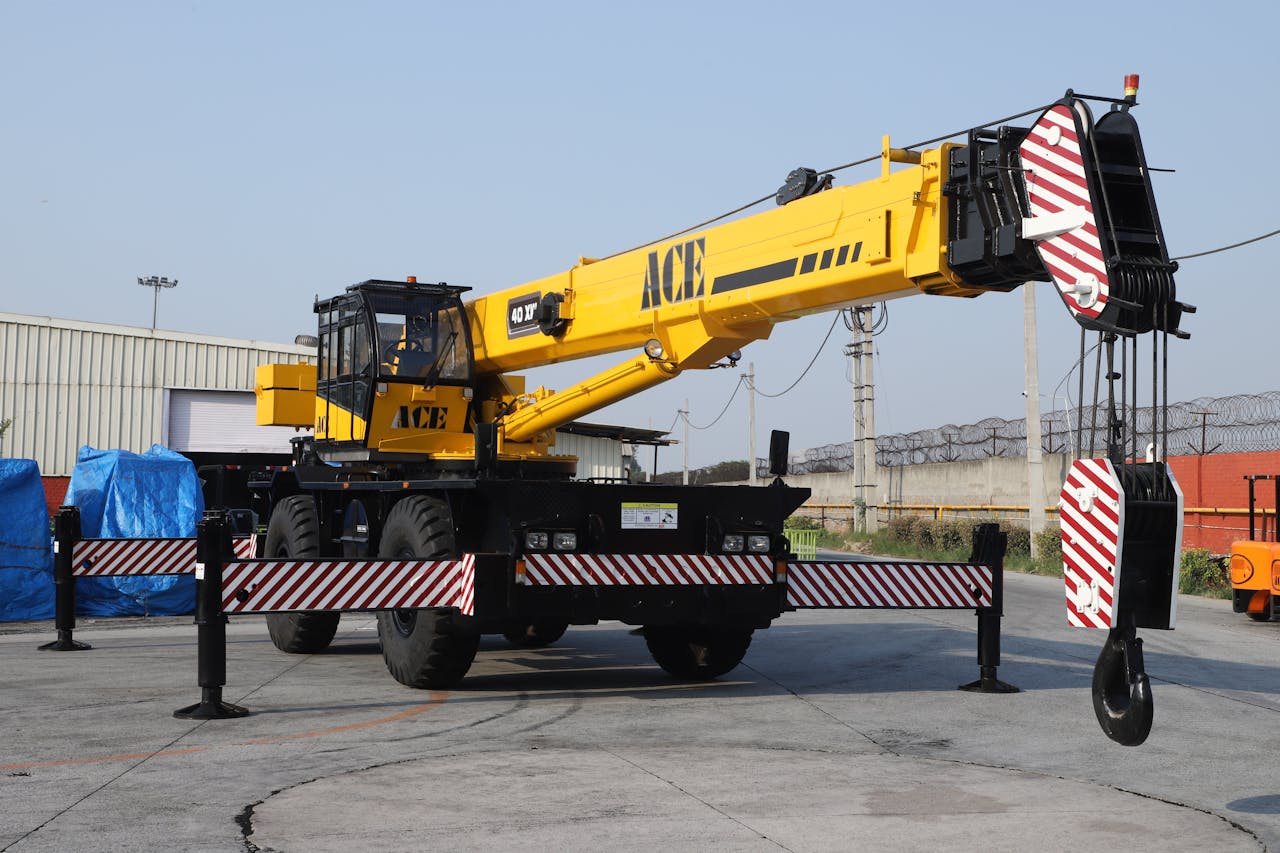 A 40 ton ACE rough terrain crane parked outdoors in an industrial yard in Faridabad, India.