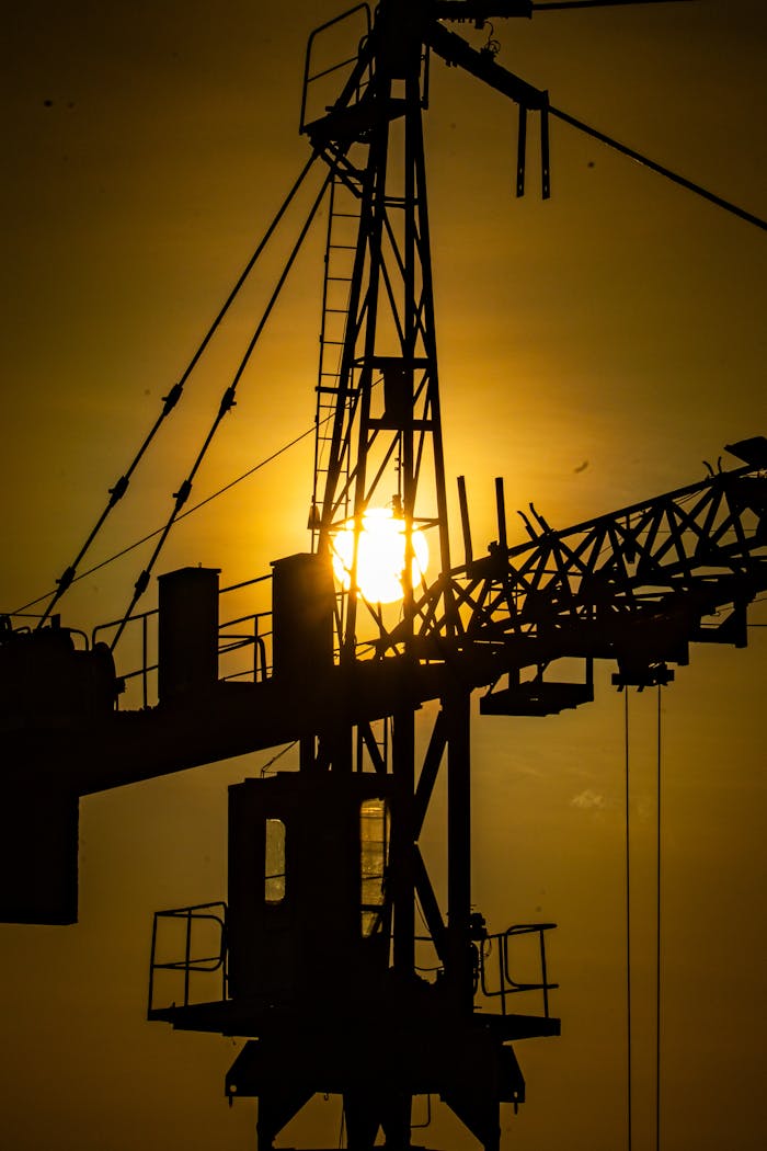 core-values Industrial crane silhouette against golden sunset, symbolizing construction progress.